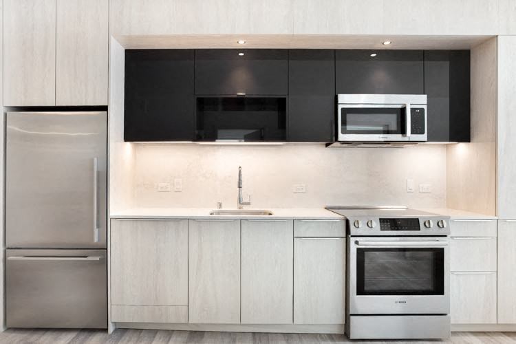 a kitchen with a stove top oven next to a refrigerator