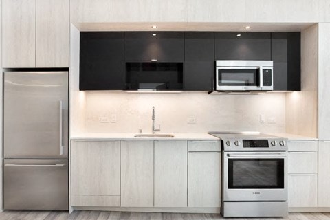 a kitchen with a stove top oven next to a refrigerator