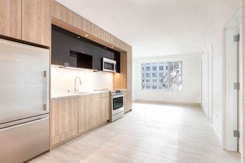 a kitchen with a stove top oven next to a window