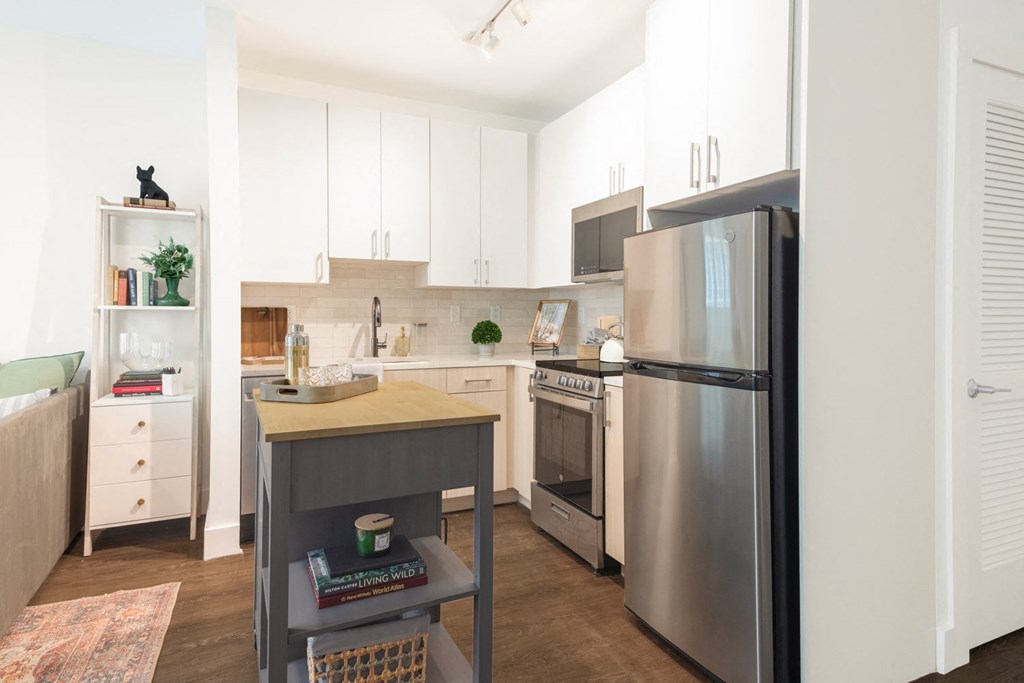 a kitchen with stainless steel appliances and white cabinets