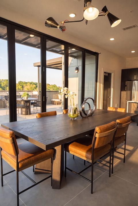A modern dining room with a large table and chairs.