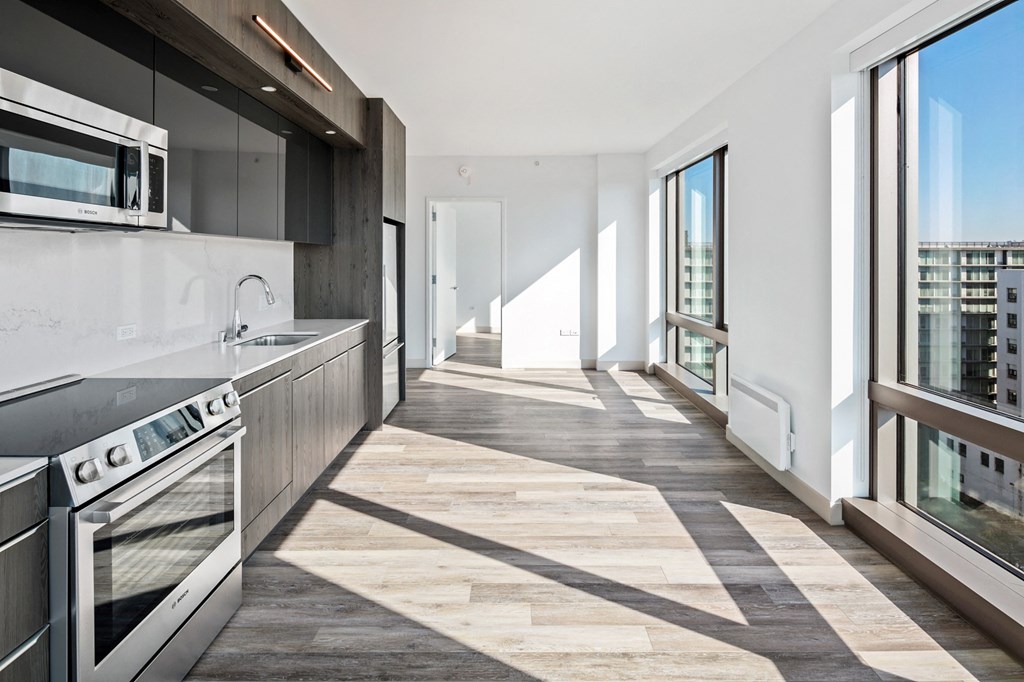 a kitchen with a stove top oven next to a window