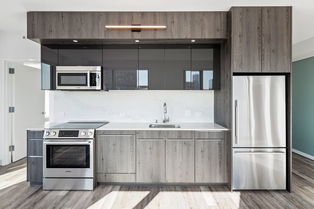 SOMA Apartments - Kitchen With Stainless Steel Appliances, Granite Countertops, Microwave, Dishwasher, Soft-Close Cabinetry, And Luxury Vinyl Floors.