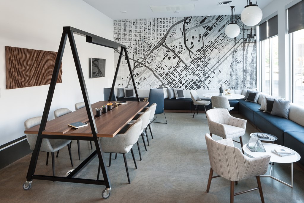 a room with a table and chairs and a large mural on the wall