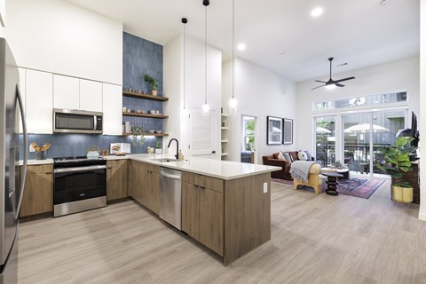 A modern kitchen with wooden cabinets and a large island.