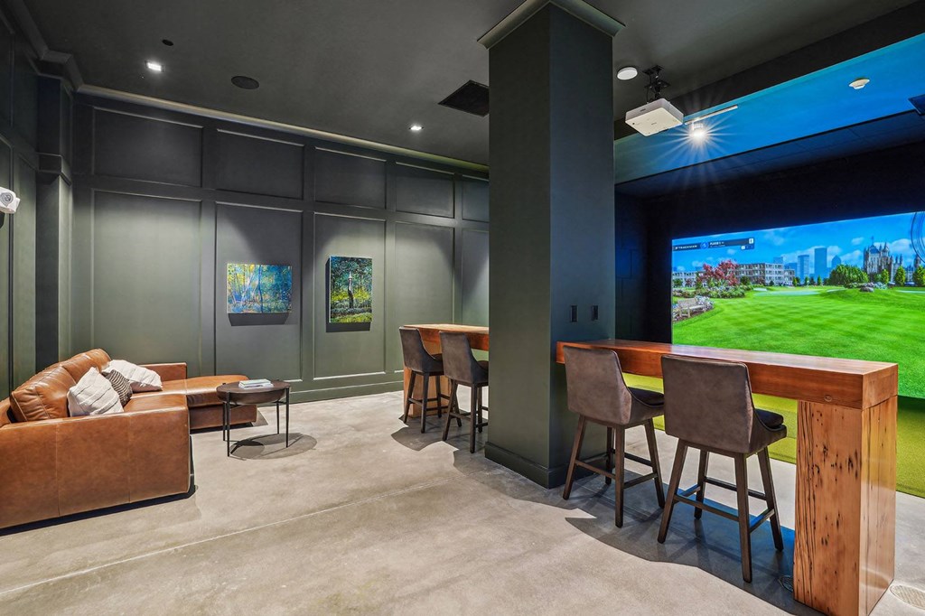 a home theater with a bar and a large screen tv