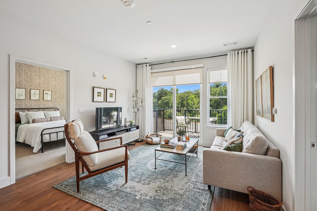 a living room with a couch and a tv and a bed