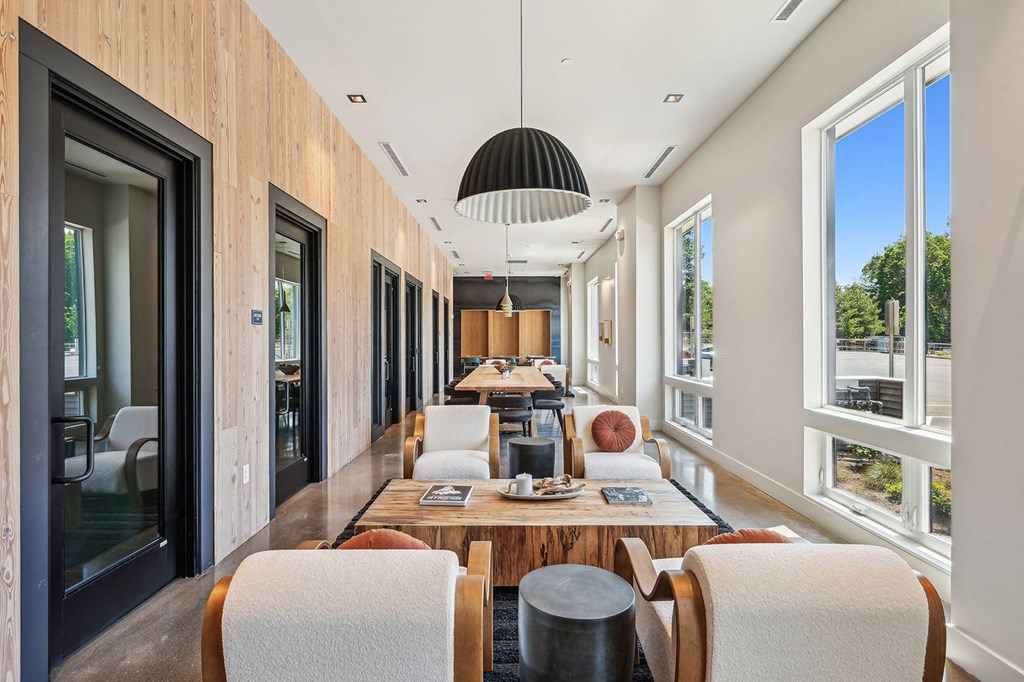 a dining room with a long table and chairs and a large window