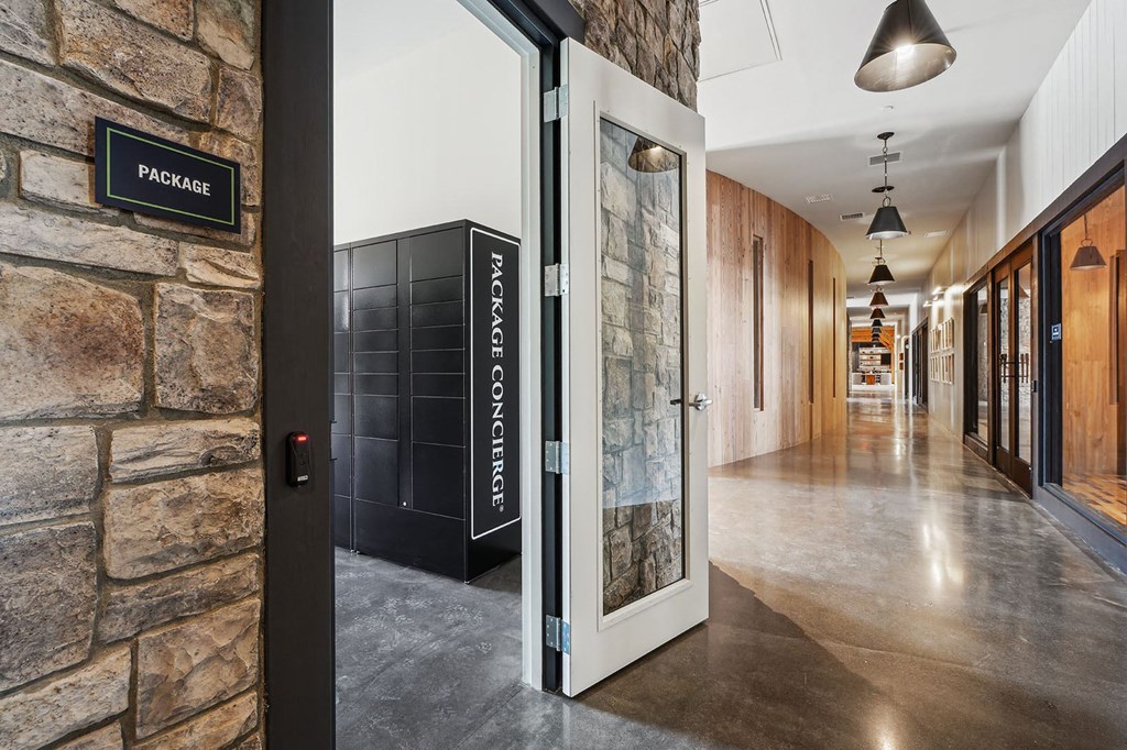 the entrance to a building with a stone wall and a glass door