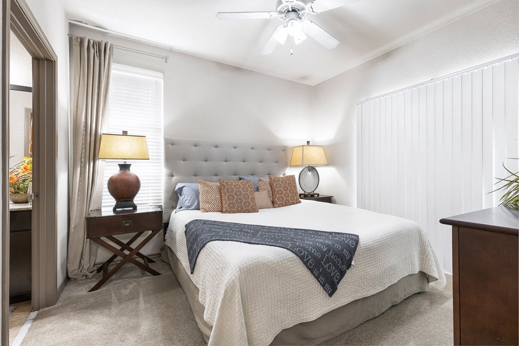 a bedroom with a bed and two lamps