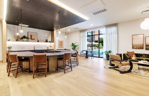A modern dining room with a large table and chairs.