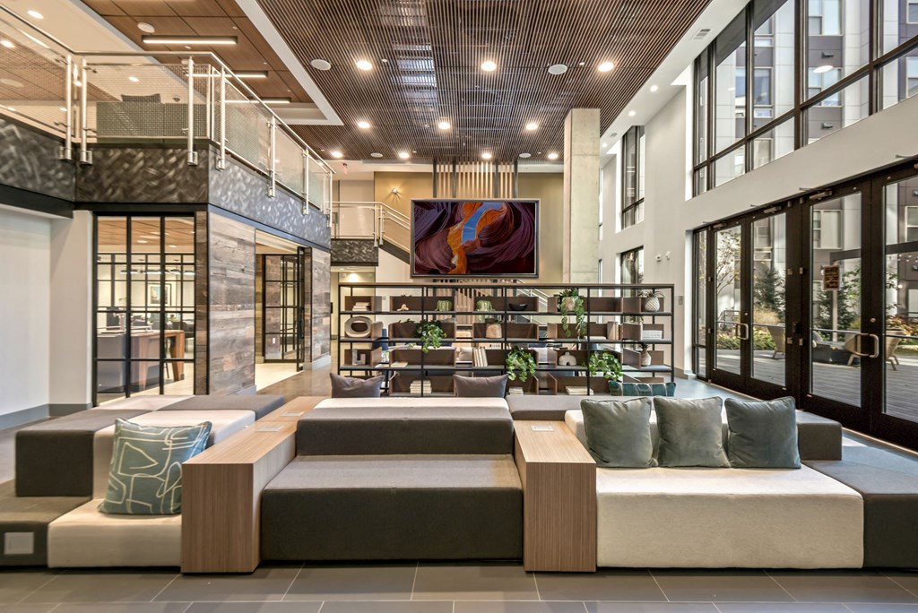the lobby of a hotel with couches and tables