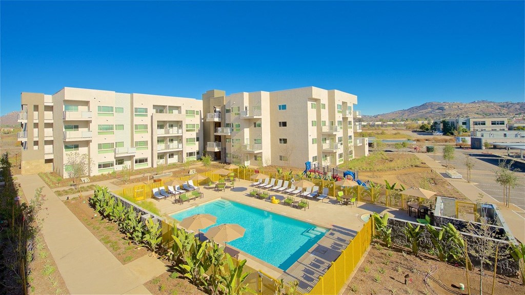 a large swimming pool in front of a building