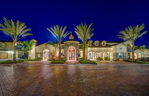 a large mansion with palm trees in front of it