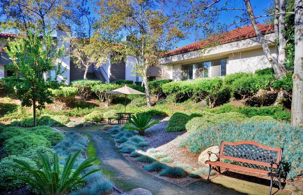 a bench in a garden in front of a building