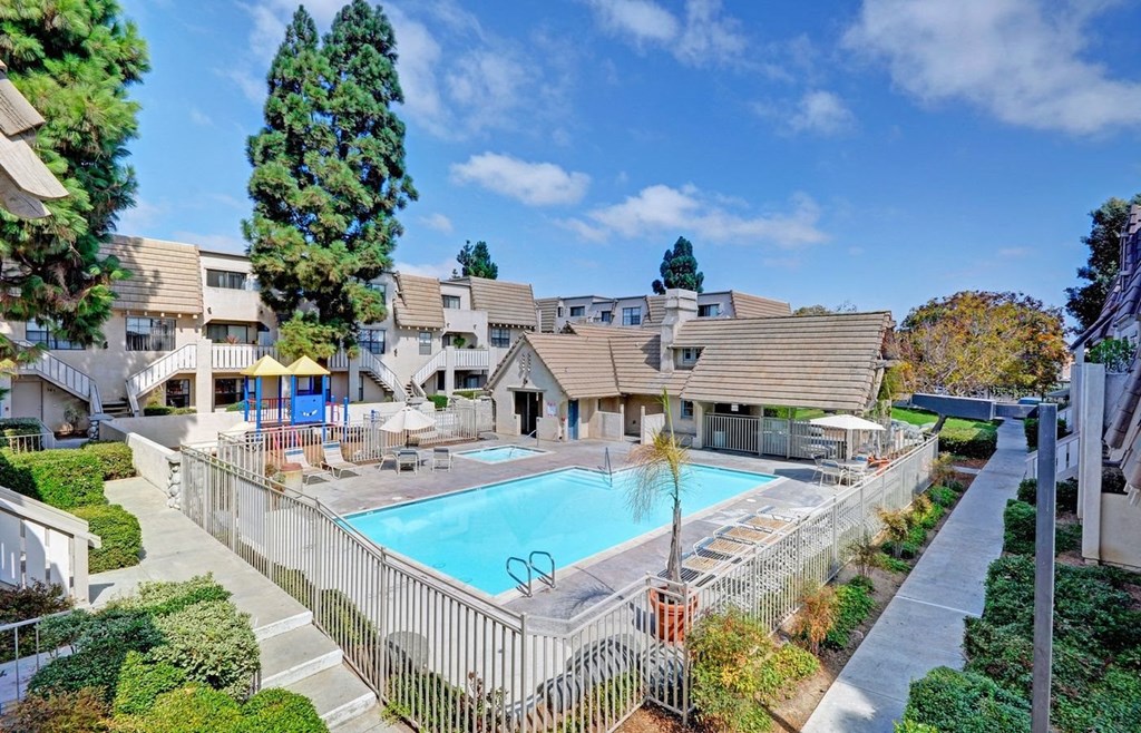 a swimming pool with apartments in the background