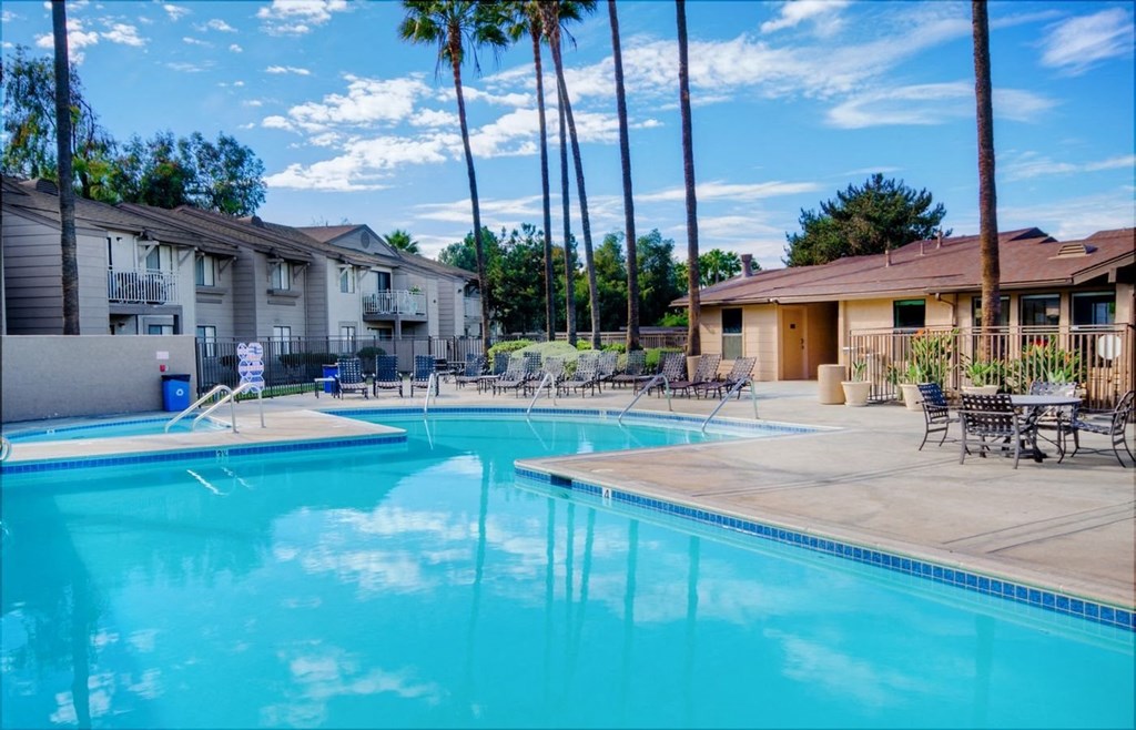 our apartments have a large swimming pool with chairs and tables