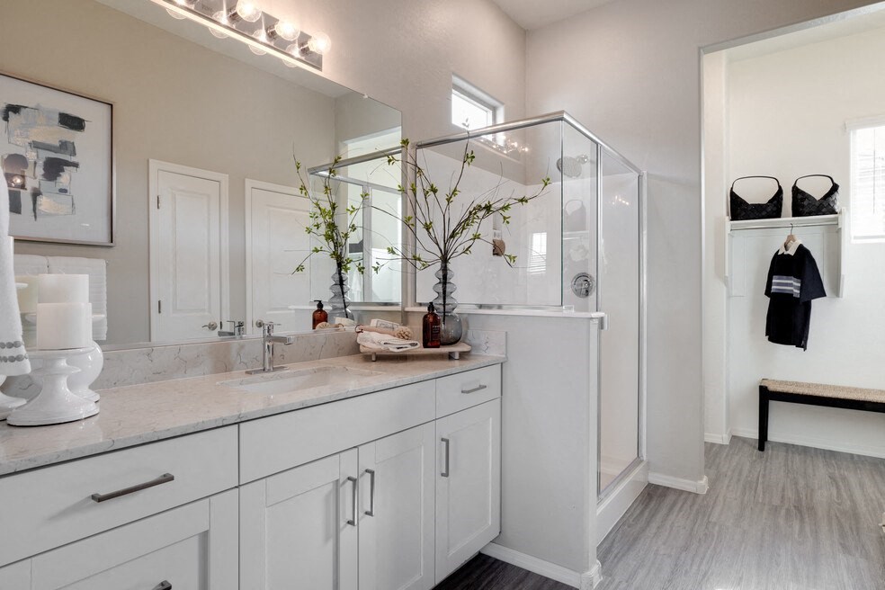 a bathroom with white cabinets and a large mirror