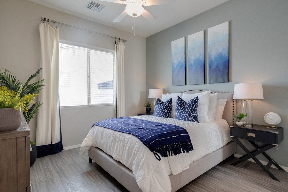 a bedroom with a bed and a ceiling fan