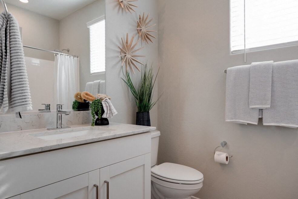 a bathroom with a toilet and a sink and a mirror