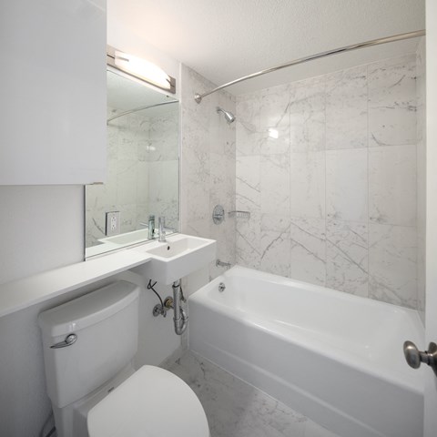 a bathroom with a toilet sink and bathtub