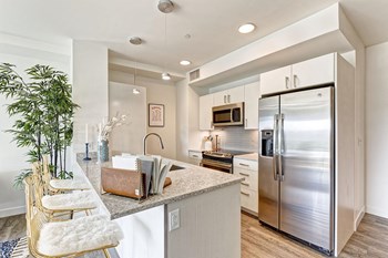kitchen with stainless steel appliances and sleek counters - Photo Gallery 3