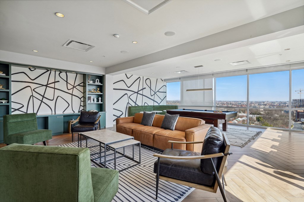 a living room filled with furniture and a large window