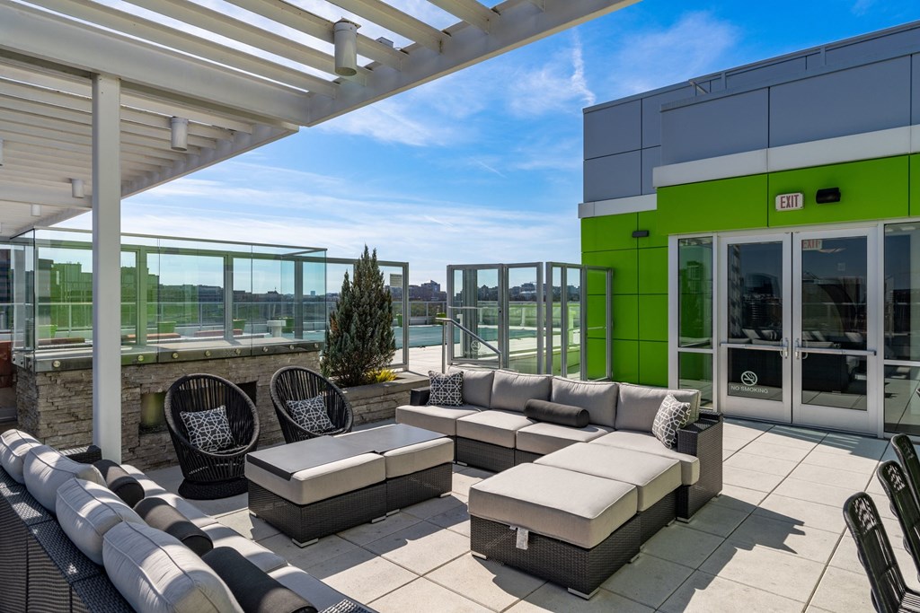 a seating area on the roof of a building with a view of the city