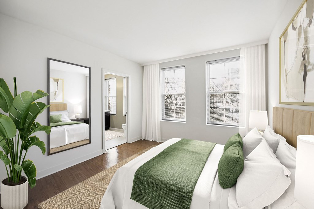 a bedroom with a large bed and a large mirror