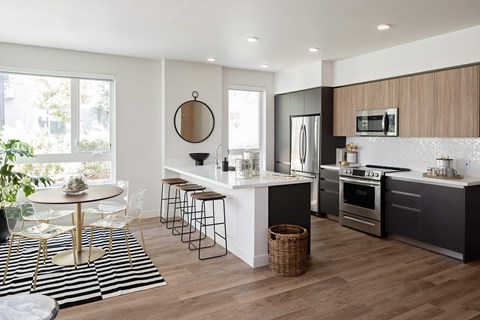 a kitchen with a white counter top and a black and white rug