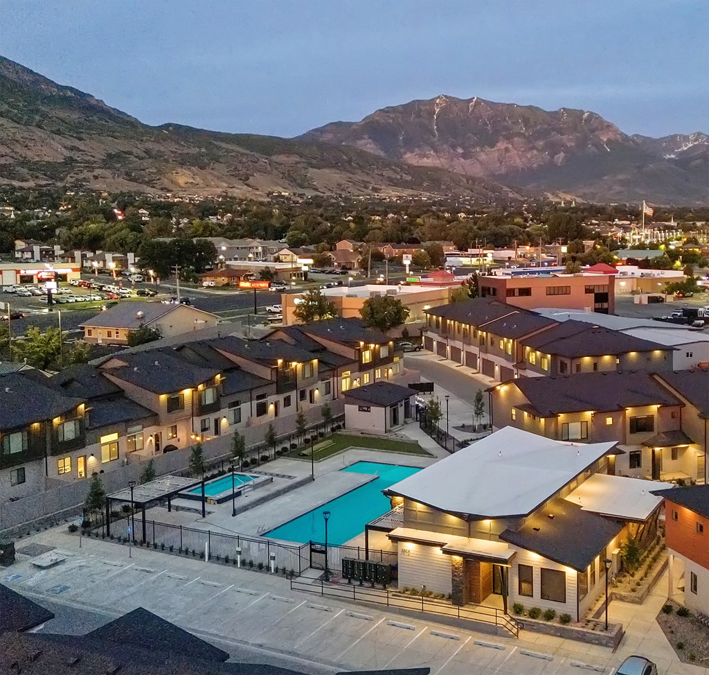 A resort with a swimming pool and a mountain in the background.