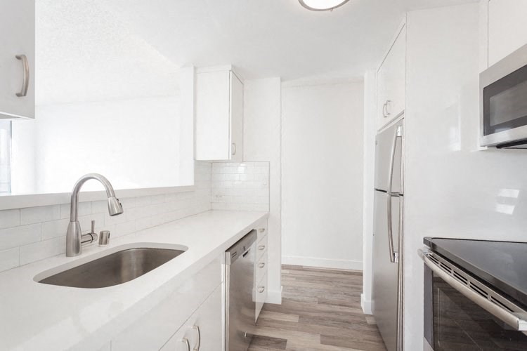 a kitchen with a sink and a refrigerator