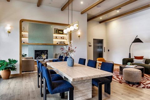 a dining room with a wooden table and blue chairs