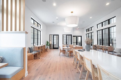 A modern dining room with wooden floors and furniture.