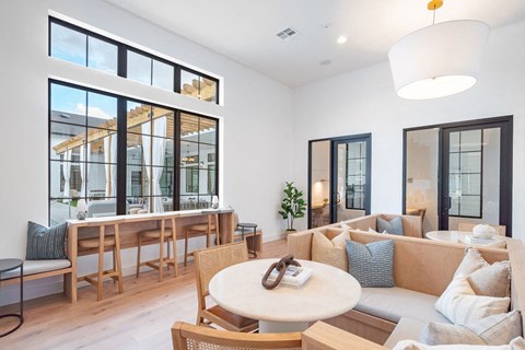 A modern living room with a large window and a white couch.