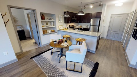 A modern kitchen with a dining table and chairs.