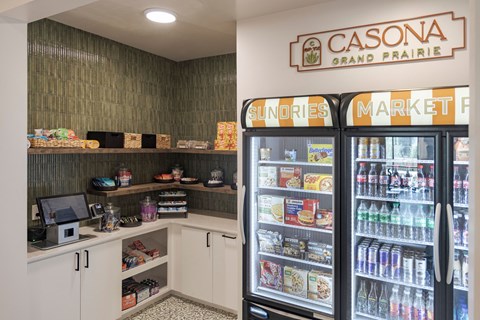 A small market with a refrigerator filled with drinks and snacks.