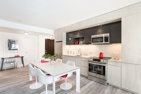 a kitchen and dining area in a 555 waverly unit