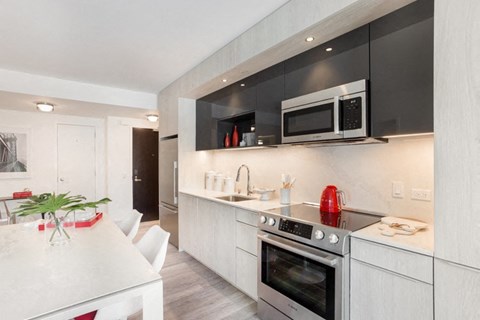 a kitchen and dining area in a 555 waverly unit