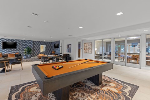 Clubhouse lounge with pool table and seating areas at The Residences at Stone Creek Apartments, Milton, 98354