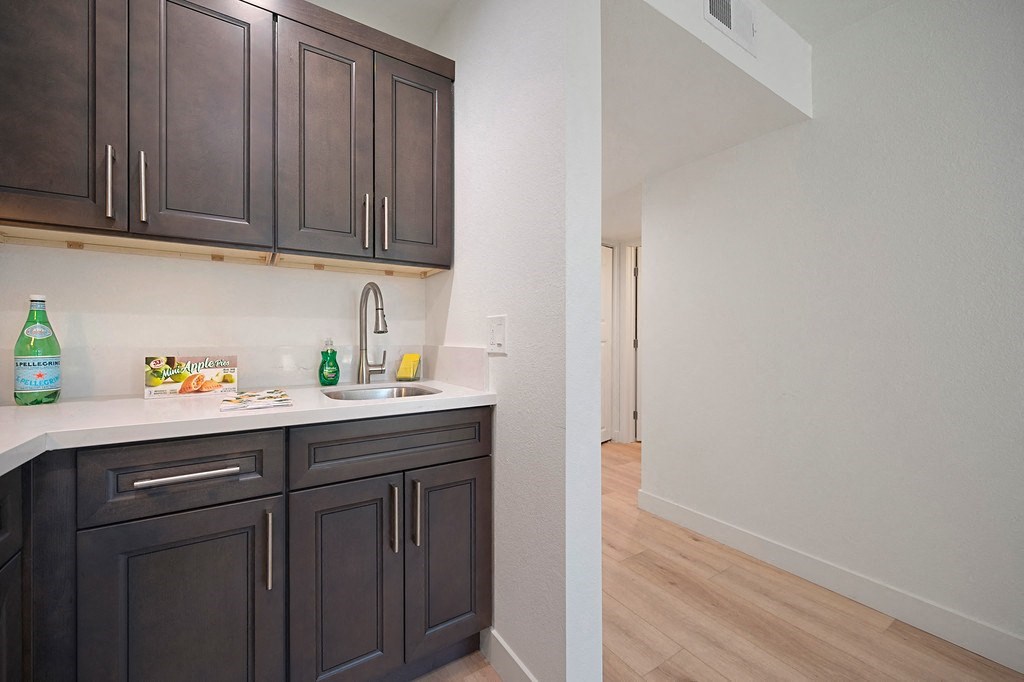 a kitchen with dark cabinets and white countertops at Citrus Heights Apartments, Citrus Heights, CA,95621