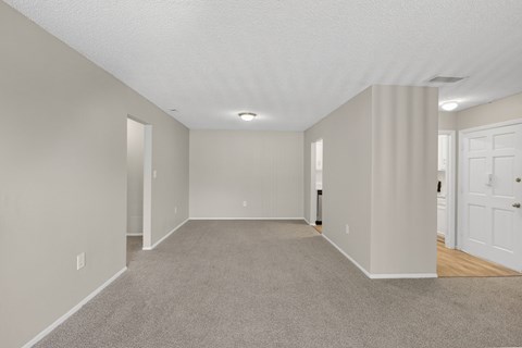 A spacious room with carpeted floor and white walls. at Foxcroft Apartments, Tampa, Florida