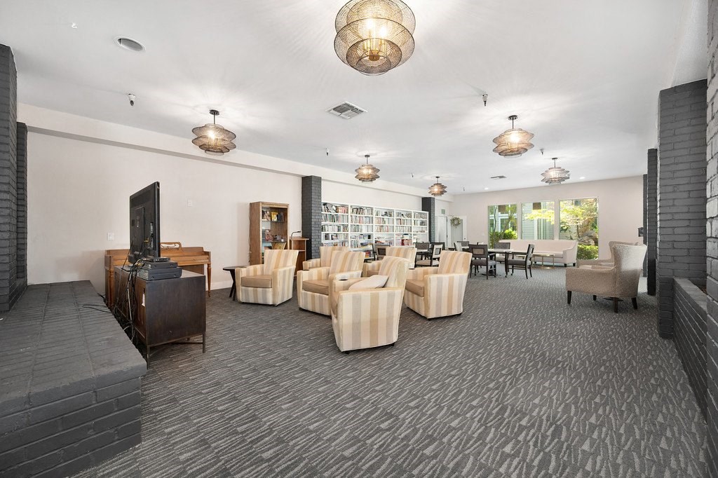 a large room with chairs and a television