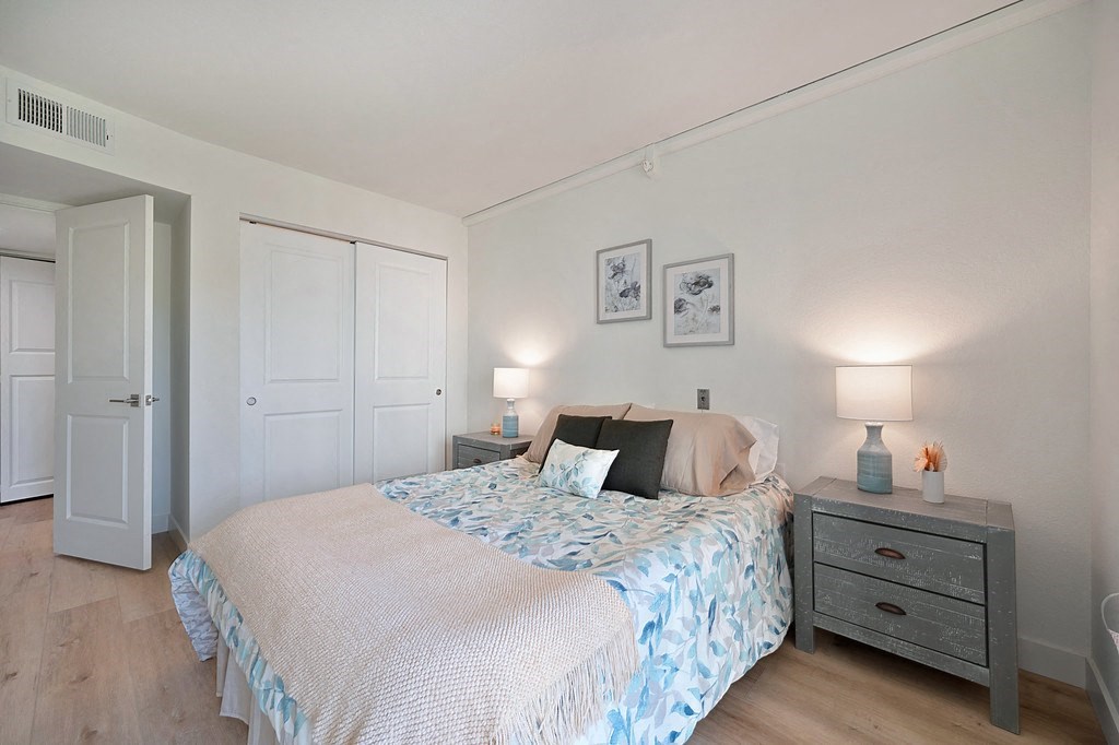 a bedroom with a bed and two night stands at The Crest at Citrus Heights Apartments, Citrus Heights, CA