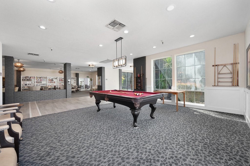 a rec room with a pool table and a bar