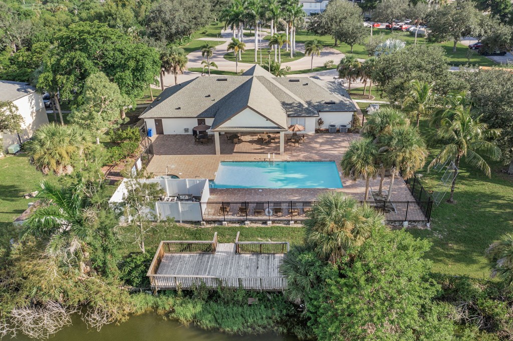 A house with a pool surrounded by trees.