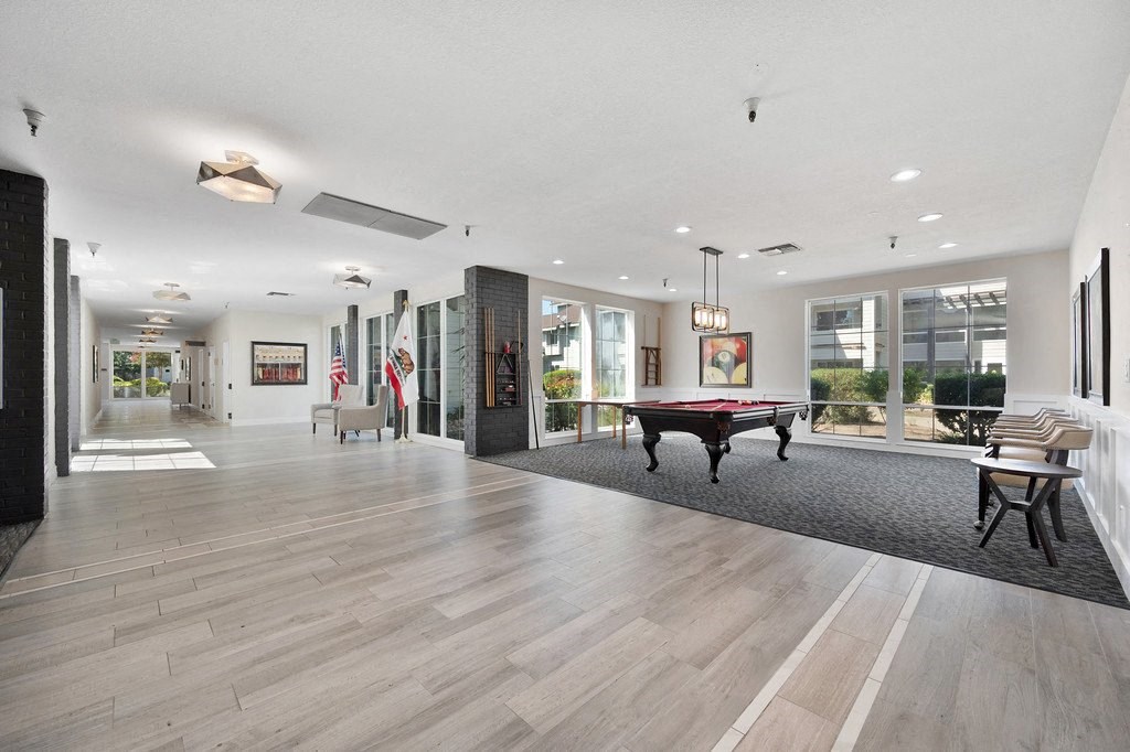 a large living room with a pool table in the middle of it