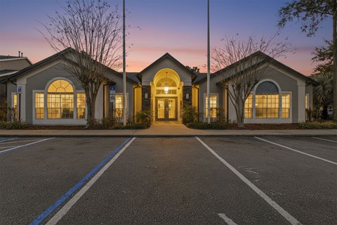 A building with a parking lot in front of it.