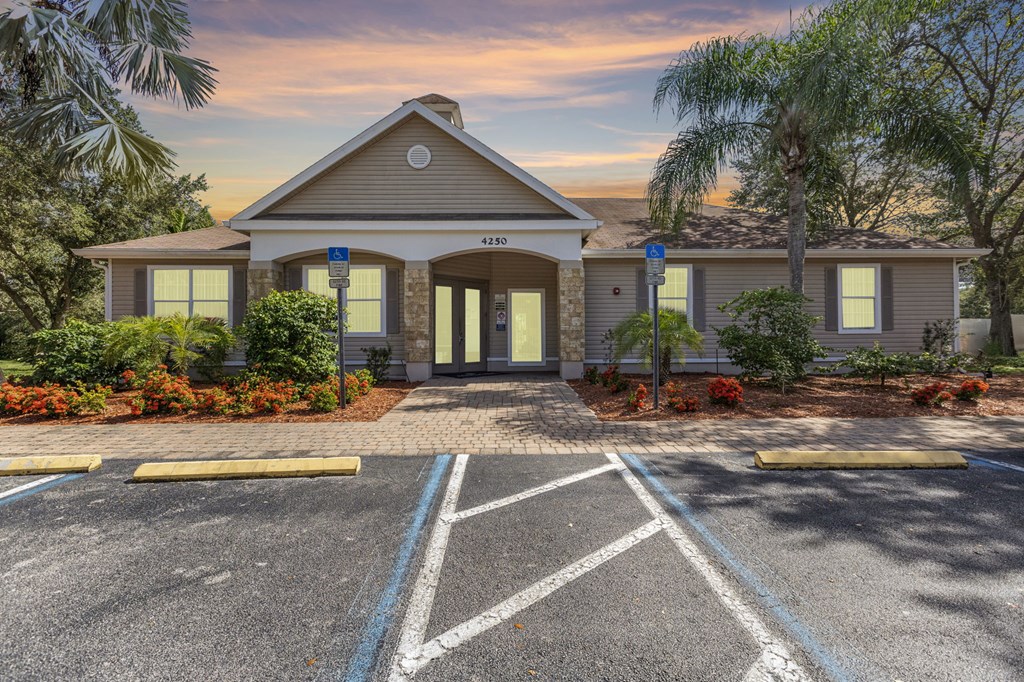 A building with a parking lot in front of it.