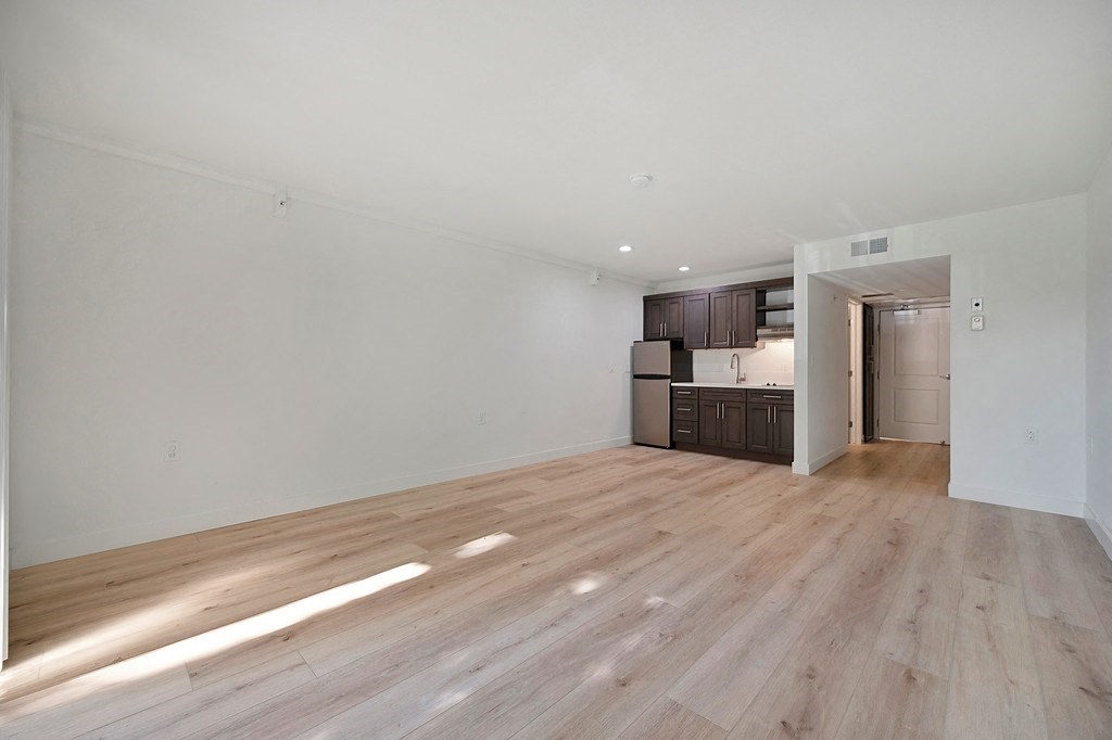 a bedroom with hardwood floors and white walls at The Crest at Citrus Heights Apartments, California, 95621
